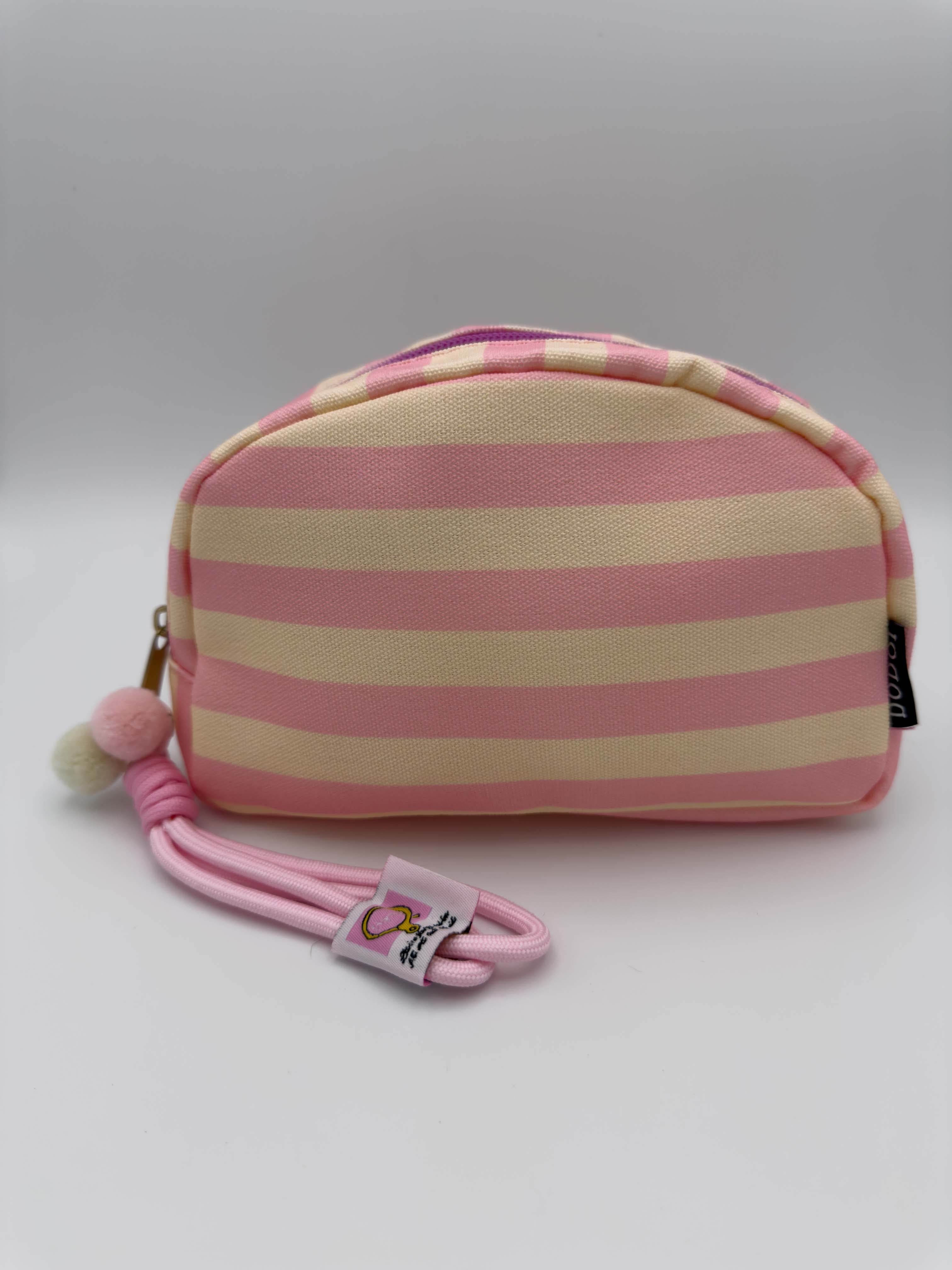 Kleine Kosmetiktasche mit rosa cremefarbenen Streifen, Reissverschluss und rosa Schlaufe mit Pompons