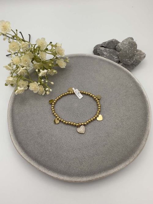 Elastisches Armband mit goldfarbenen Metallperlen und Herzanhaenger
